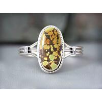 large oval green, gold, orange with dark brown matrix treasure mountain turquoise cabochon bezel set accented twisted wire on silver cuff